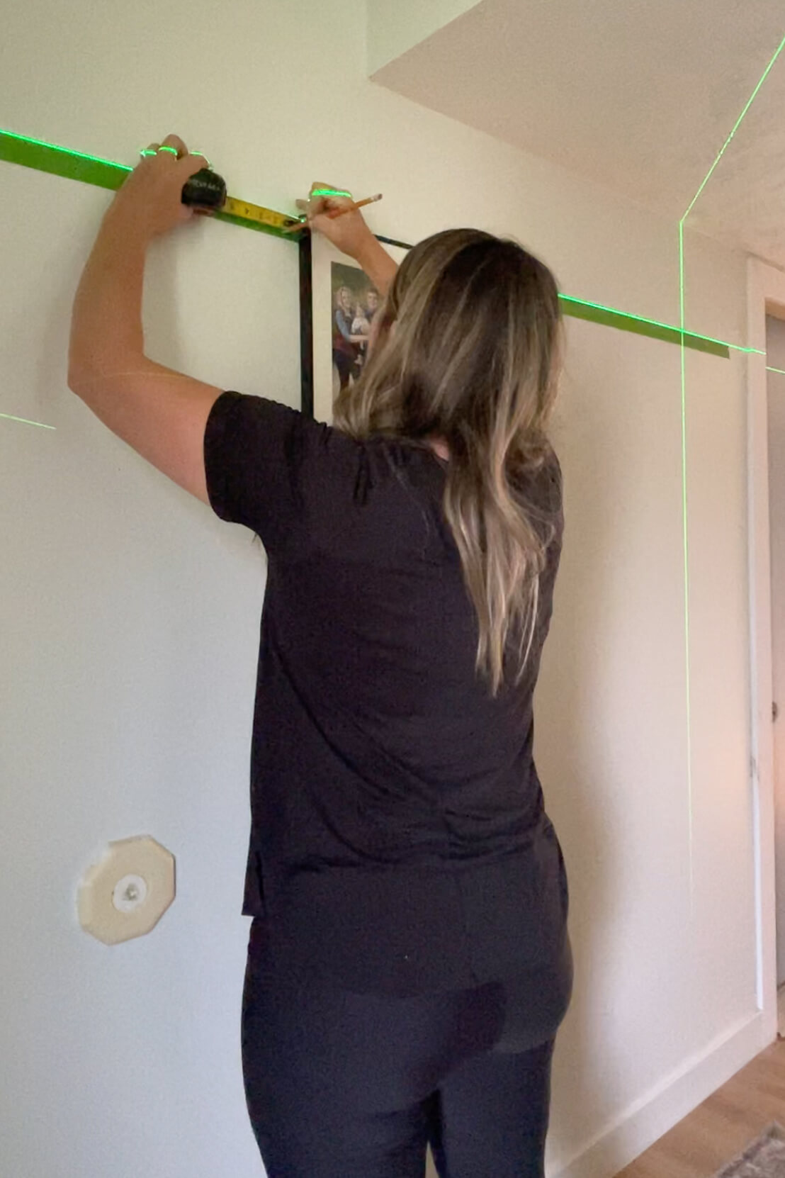 Measuring for hanging a gallery wall layout. 